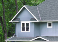 A picture of a clean rooftop gable with moss or black streaks on roof shingles