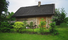 A picture of a backyard residential barn with moss and dirt removed from wood cabin with roof shingles demossed,